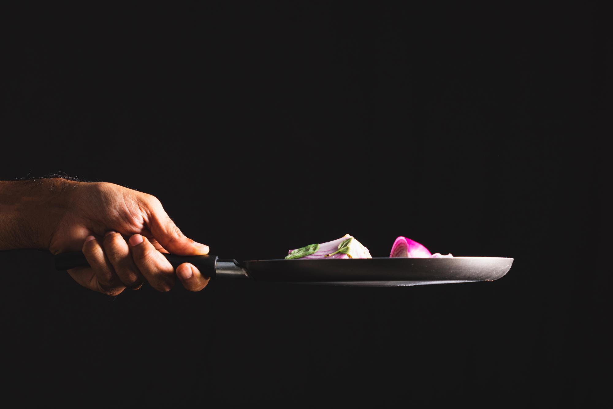 Chef preparing a modern plated dish with tech equipment